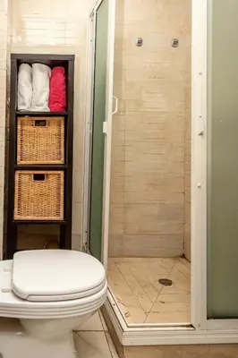 a bathroom with a shower with a toilet and towels at Appartement Panoramique in Casablanca