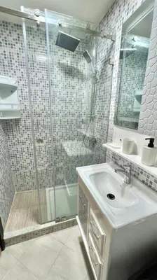 a bathroom with a glass shower and a sink at T6 Appartement entièrement neuf au cœur de Témara in Temara
