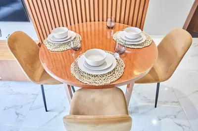 a wooden table with chairs and a table with cups and saucers at Chic and Cozy 1 Bedroom Oasis in the Heart of Casa in Casablanca