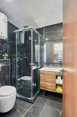 a bathroom with a shower and a toilet and a sink at Chic and Cozy 1 Bedroom Oasis in the Heart of Casa in Casablanca