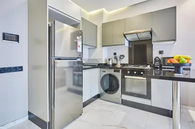 a kitchen with a washer and dryer at Chic and Cozy 1 Bedroom Oasis in the Heart of Casa in Casablanca