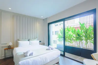 a bedroom with a large bed and a large window at Résidence Jade in Casablanca