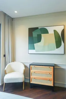 a living room with a chair and a dresser at Résidence Jade in Casablanca