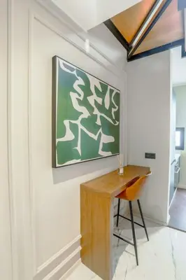 a desk in a room with a painting on the wall at Résidence Jade in Casablanca