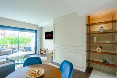 a living room with a table and blue chairs at Résidence Jade in Casablanca
