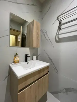 a bathroom with a white sink and a mirror at Appartement Cosy Agdal Centre Rabat in Rabat