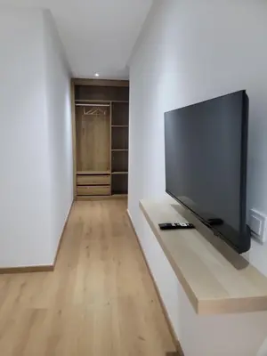 a living room with a flat screen tv on a wall at Eden Room SCH in Rabat
