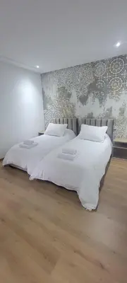 two beds in a room with white sheets at Eden Room SCH in Rabat