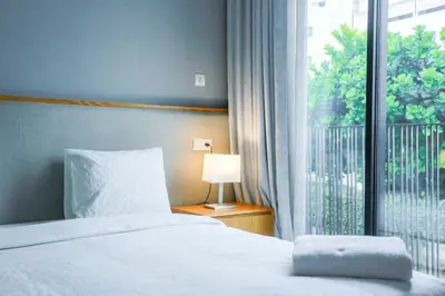 a bedroom with a bed and a large window at Résidence B-Livin - La Ferme Bretonne in Casablanca