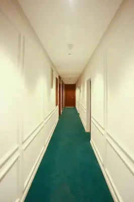 an empty hallway with a green floor in a building at Résidence B Livin - Oasis in Casablanca