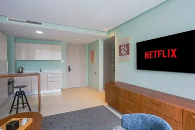 a kitchen with a netflix sign on a wall at Résidence Anfa Sunset - Ain Diab Casablanca Beach in Casablanca