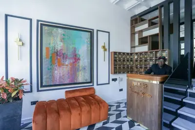 a man is sitting at a counter in a room at Résidence Palm - Palmiers in Casablanca