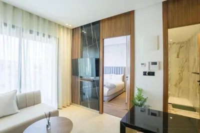 a living room with a couch and a bed at Résidence Palm - Palmiers in Casablanca