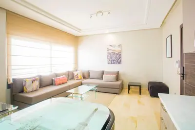 a living room with a couch and a table at Résidence Urban Square F26 in Casablanca