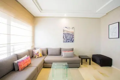 a living room with a couch and a glass table at Résidence Urban Square F26 in Casablanca