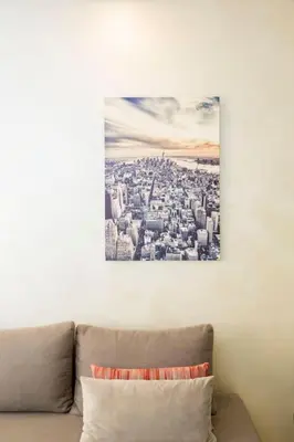 a picture of a city on the wall above a couch at Résidence Urban Square F26 in Casablanca