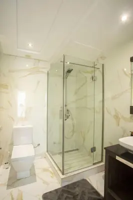 a bathroom with a shower and a toilet and a sink at Résidence Urban Square F26 in Casablanca