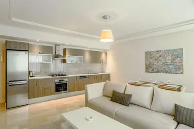 a living room with a couch and a kitchen at Résidence Urban Square D52 in Casablanca