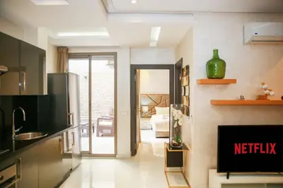 a kitchen with a view of a living room at Résidence Sheren - Maarif in Casablanca