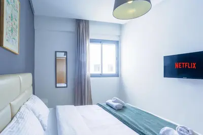 a bedroom with a bed and a window at Résidence Liberté in Casablanca