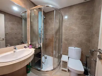 a bathroom with a shower and a toilet and a sink at Appartement chic avec Terrasse in Casablanca