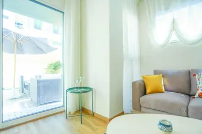 a living room with a couch and a table and a window at Résidence Doribel in Casablanca