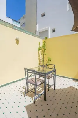 a table and two chairs with a plant on it at Résidence Doribel in Casablanca