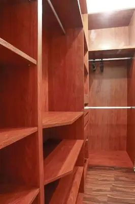 a walk in closet with wooden shelves at Résidence Doribel in Casablanca