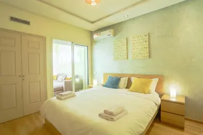 a bedroom with a large bed with towels on it at Résidence Doribel in Casablanca