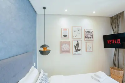 a room with a bed and pictures on the wall at Résidence de Nice in Casablanca