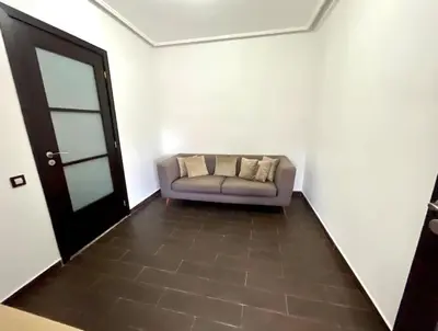 a couch sitting in a room with a door at Luxury villa with private pool in Casablanca