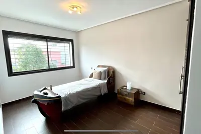a small bedroom with a bed and a window at Luxury villa with private pool in Casablanca
