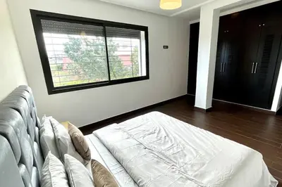 a living room with a couch and a window at Luxury villa with private pool in Casablanca