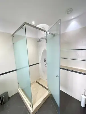 a glass shower stall in a bathroom with a toilet at Luxury villa with private pool in Casablanca