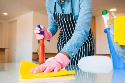 a woman in pink gloves cleaning a table with a sponge at #23 New Charming Casablanca Retreat/keyless door in Casablanca