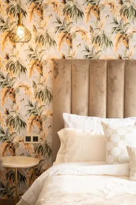 a bedroom with a bed and a wall with plants at Keyless Smart door/ New /Free parking/Central in Casablanca