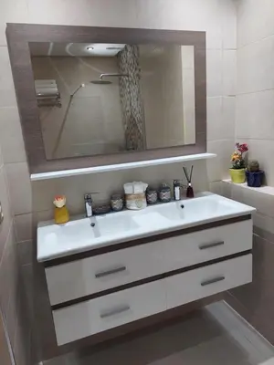 a bathroom with a white sink and a mirror at Chabili Appartements in Temara