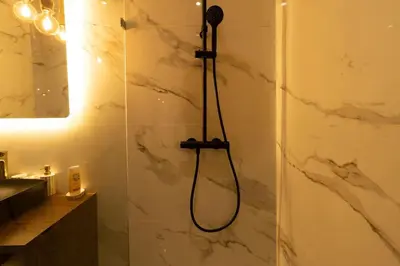 a shower with a shower head in a bathroom at Charming & Airy Flat - Perfect for Relaxation in Casablanca
