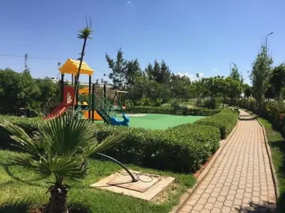 a playground in a park with at Best appartement pools view at Mansouria in Mohammedia