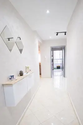 a large white room with a counter and a tile floor at Cozy appartement à Mohammedia in Mohammedia