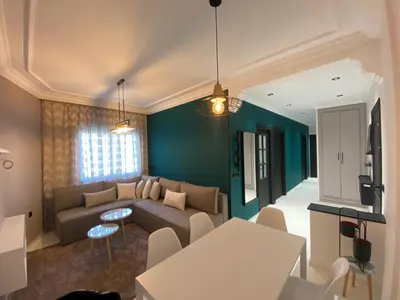 a living room with a couch and a table at RABAT RESIDENCE - Apartments in Rabat
