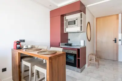 a kitchen with a wooden table and a microwave at Tribeca 3 - Casablanca Center in Casablanca