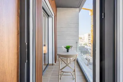 a small table in a balcony with a view of a city at Tribeca 3 - Casablanca Center in Casablanca