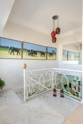a room with paintings of elephants on the wall at 4 min à pied de la Plage, 3 BR, Piscine, Parking in Skhirat