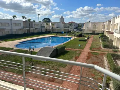 a view of a swimming pool at a apartment complex at Savannah beach sidi Rahal in Dar Hamida