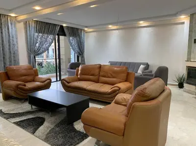 a living room with a couch and chairs and a table at Beautiful 3BR apartment in Hay Riad Rabat in Rabat