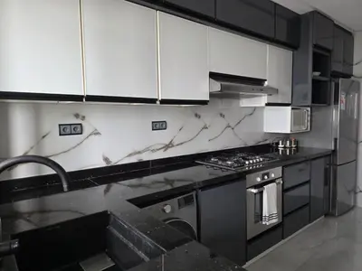 a kitchen with black and white marble counter tops at Beautiful 3BR apartment in Hay Riad Rabat in Rabat