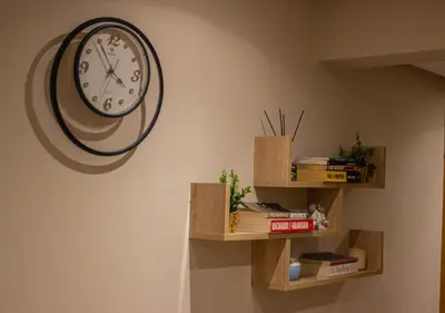 a clock hanging on a wall next to wooden shelves at R101- Cosy and stylish apartment with King Size Bed- Belvédère in Casablanca