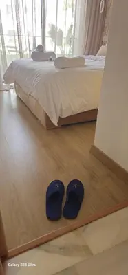 a pair of blue shoes sitting on the floor next to a bed at Cosy & Confort Studio près de l'aéroport in Nouaceur