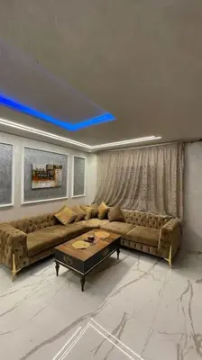 a living room with a couch and a table at Modern rez de villa, jack beach Tamaris, Dar Bouaza in Casablanca